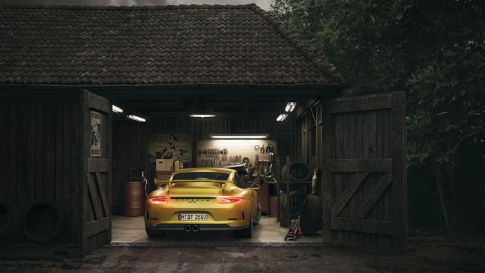 Yellow Porsche GT3 in a rustic garage
