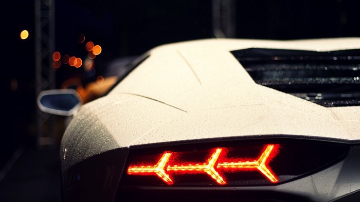 White Lamborghini Aventador taillight at night