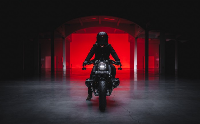BMW motorcycle rider in a dark tunnel with red lighting