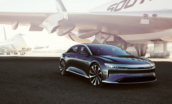 Lucid Air car parked near airplanes