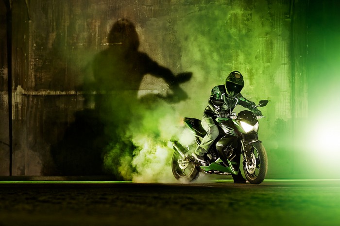 Kawasaki Z300 motorcycle drifting with green smoke