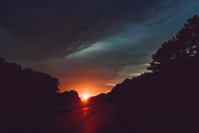 Sunset over a highway with trees