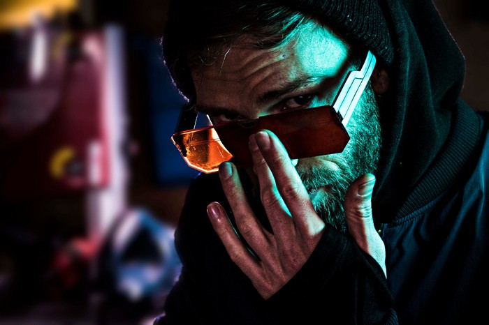 Man wearing futuristic sunglasses and hoodie
