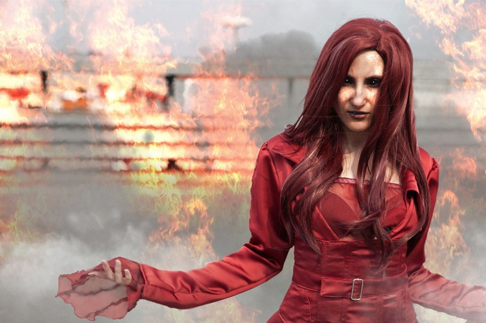 Jean Grey in a red costume with fire in the background