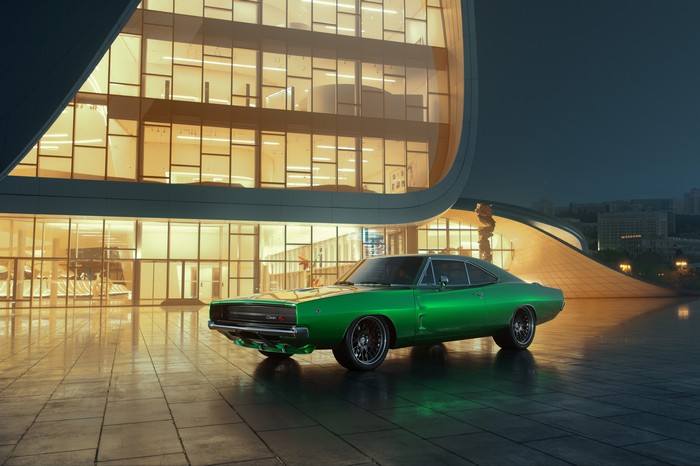 Green Dodge Charger parked in front of a modern building