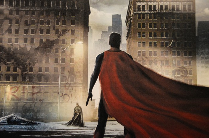 Superman and Batman in a ruined city painting