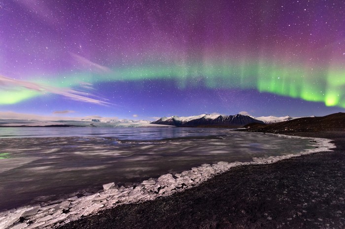 Aurora Borealis over a glacial landscape in Iceland