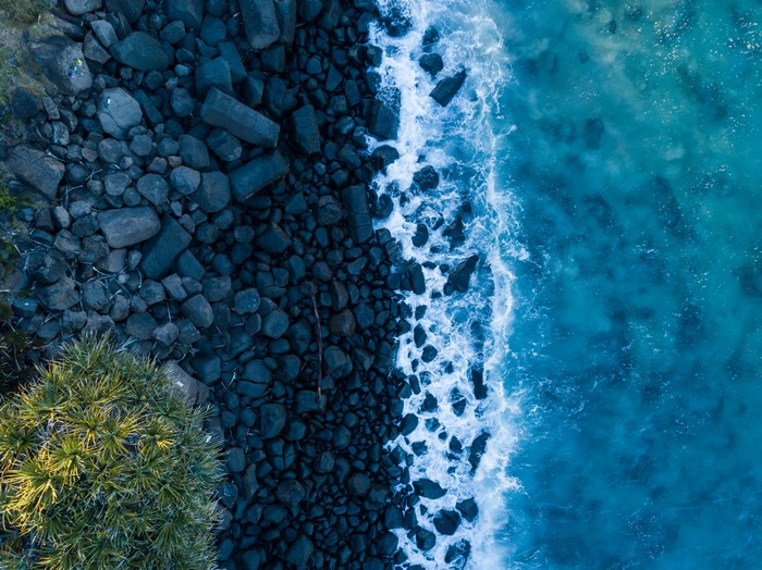Aerial view of rocky coastline and blue sea
