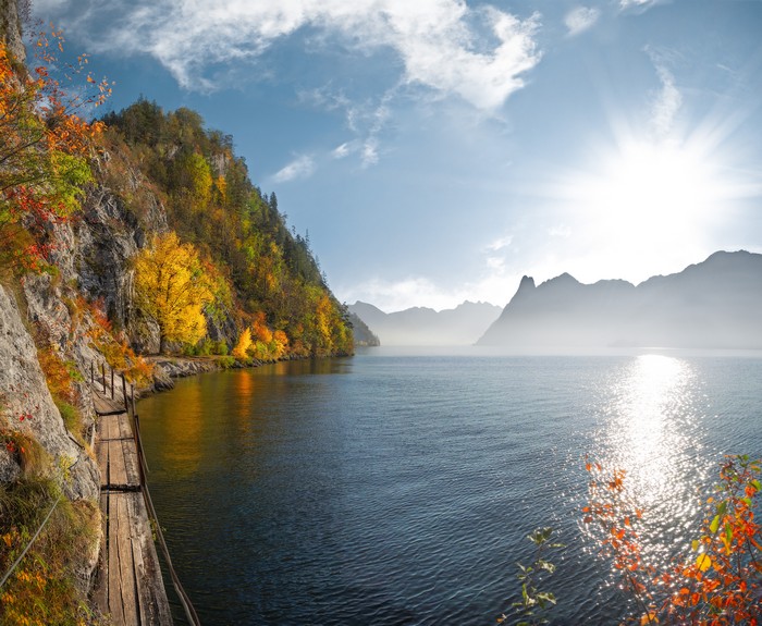 Autumn lake with mountains and wooden path