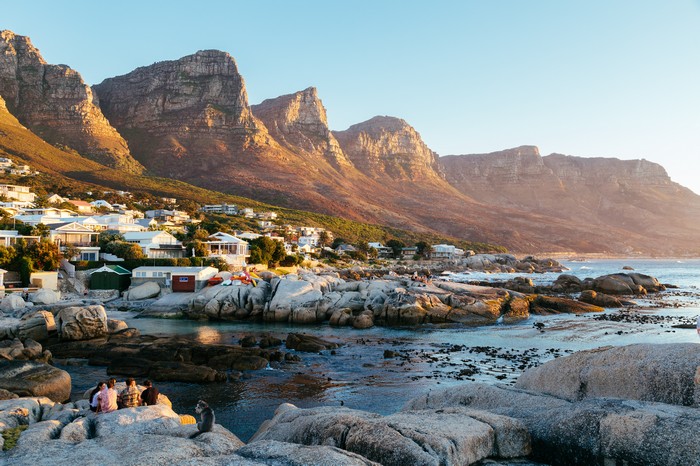 Coastal town with mountains at sunset
