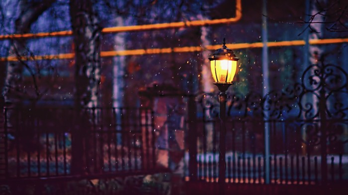 Street lamp in winter with falling snow