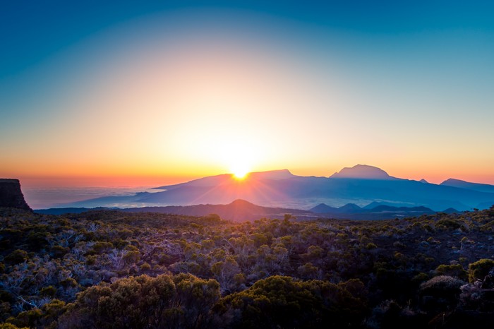 Sunrise over mountains and rugged terrain