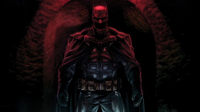Batman in a dark cave with red lighting