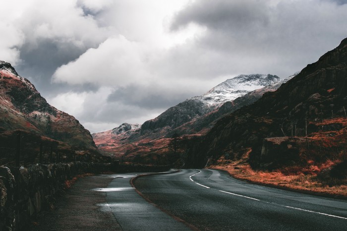 Road through mountains with snow-capped peaks