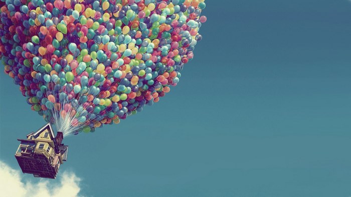 House lifted by balloons in the sky
