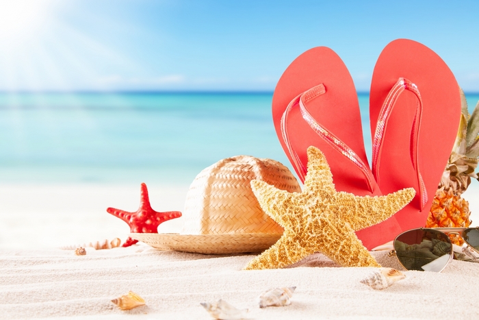 Summer beach scene with flip-flops and starfish