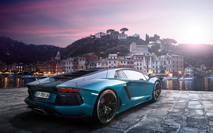 Lamborghini Aventador parked by a harbor at sunset