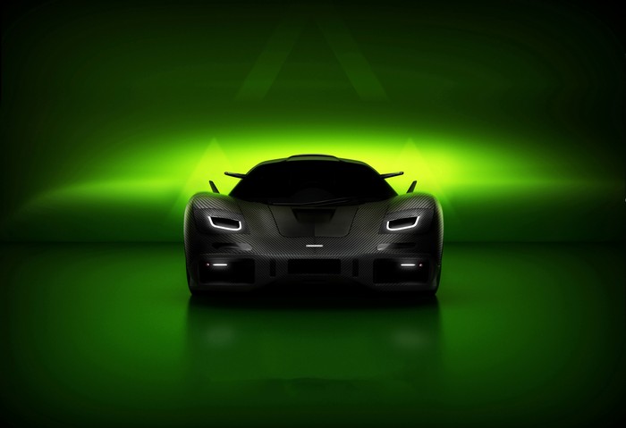 Black McLaren F1 car on a green background