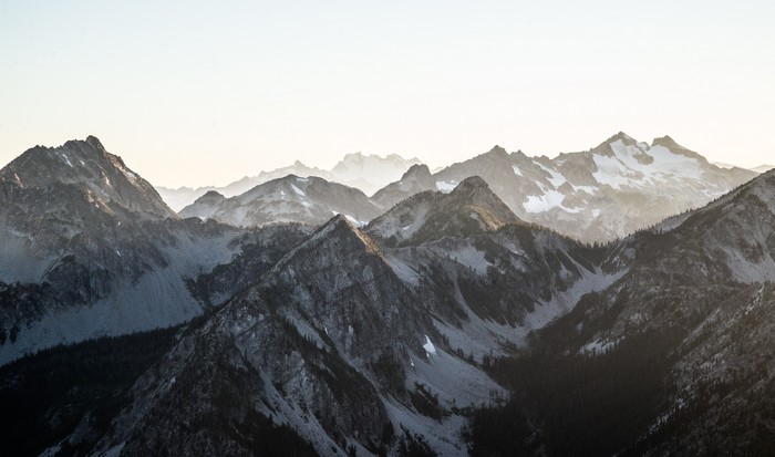 Snow-capped mountains under a bright sky