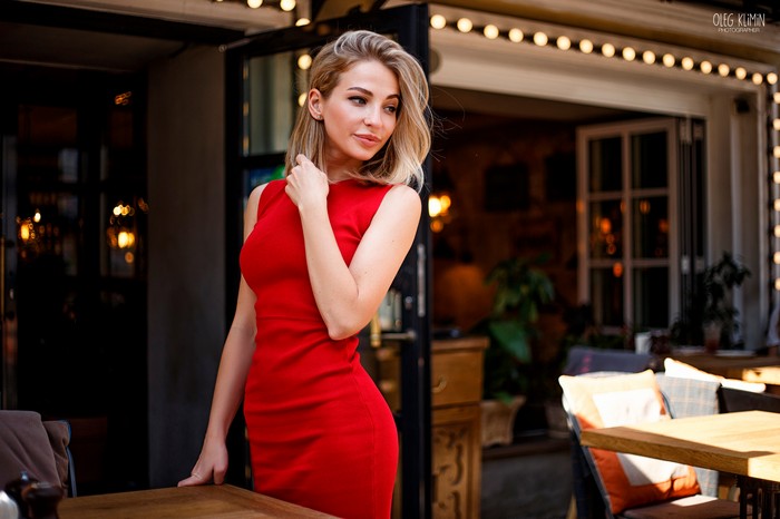 Woman in a red dress at an outdoor cafe
