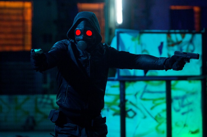 The Awakener character with red glowing eyes and guns