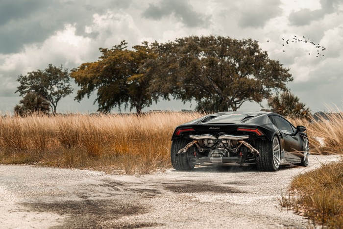 Black Lamborghini Huracan on a dirt road