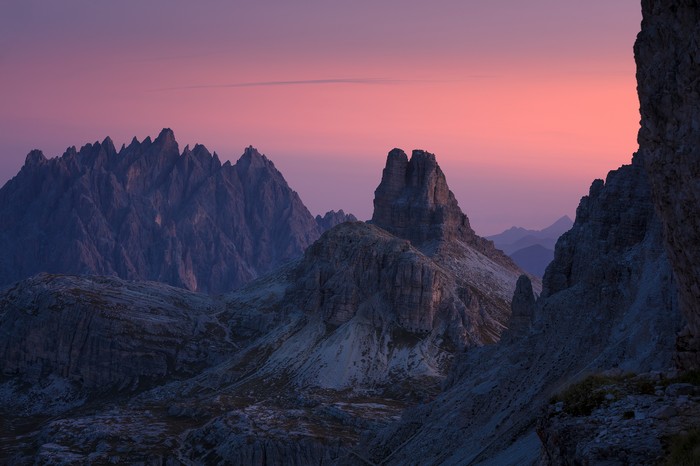 Jagged mountains at sunset with pink sky