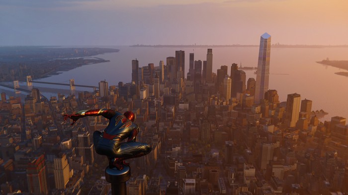Spider-Man crouches on a skyscraper overlooking New York City