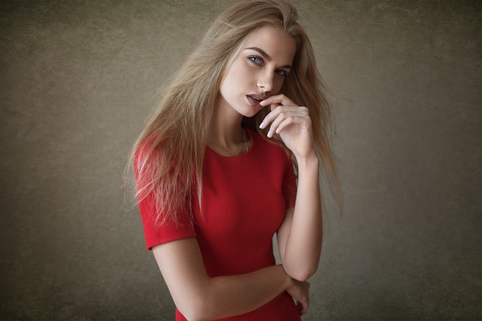 Blonde Woman in Red Dress Posing Thoughtfully