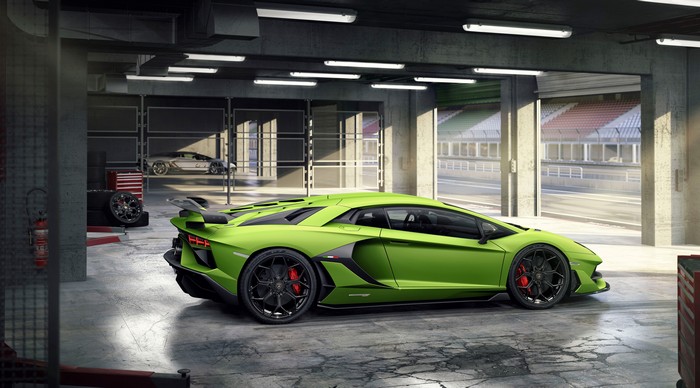 Green Lamborghini Aventador SVJ in a garage