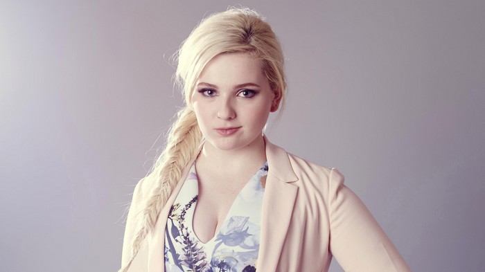 Abigail Breslin in a pink blazer and floral dress