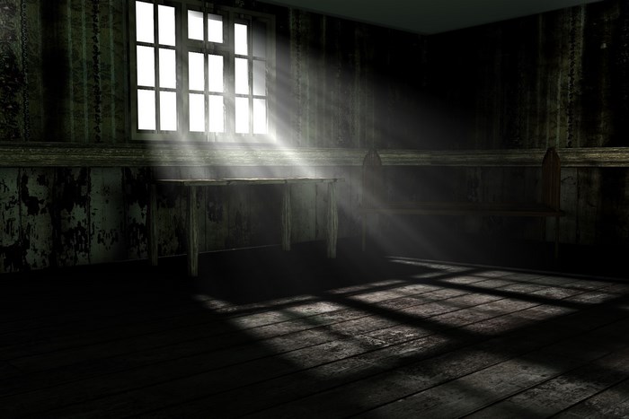 Dark room with light rays through window