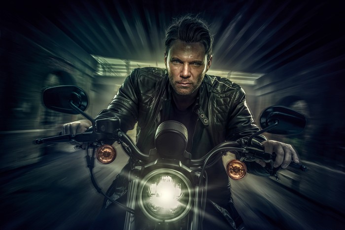 Man riding a Harley Davidson motorcycle
