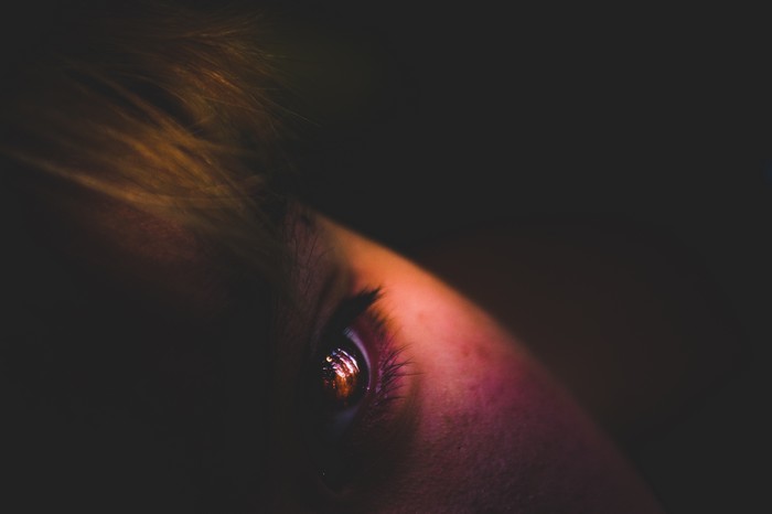 Close-up of a human eye with galaxy reflection