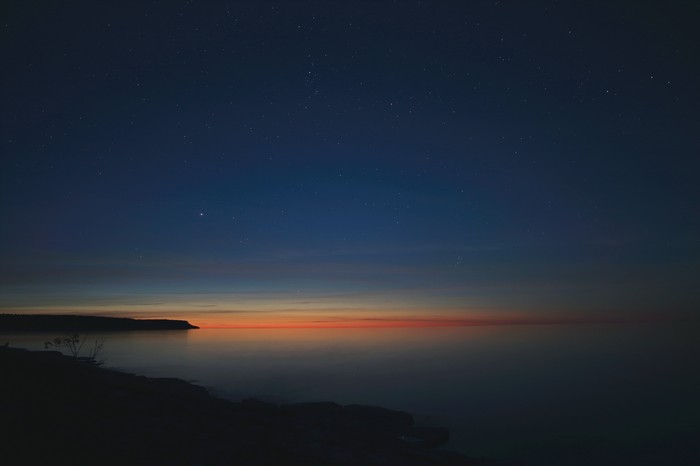 Sunset over the ocean with stars