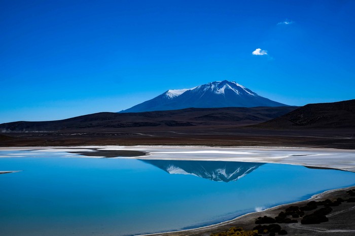 Snow-capped mountain reflected in a blue lake