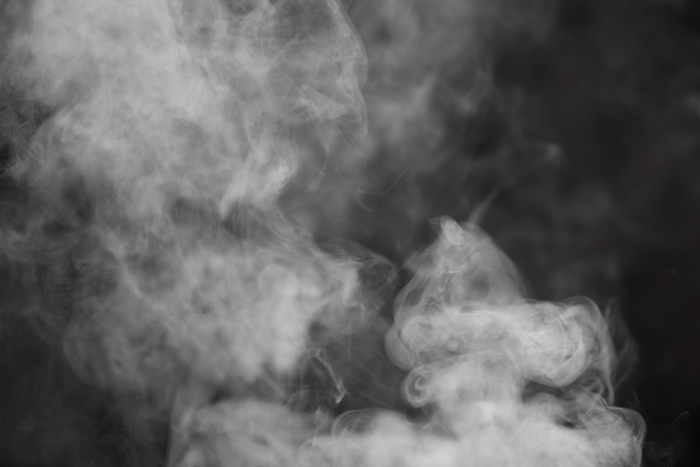 Smoke wisps against a dark background