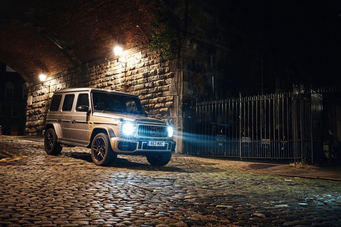 Mercedes G-Class parked on cobblestone street at night