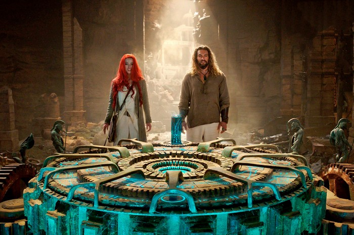 Aquaman and Mera stand near a glowing device