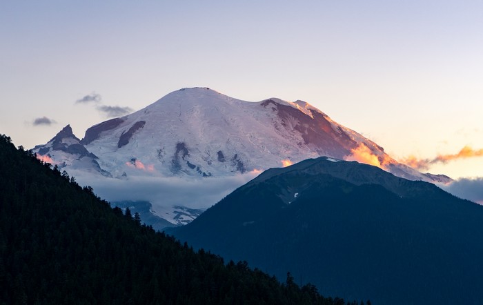 Snow-capped mountains at sunset with clouds