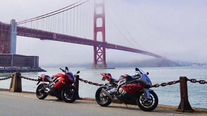 Two motorcycles parked near the Golden Gate Bridge