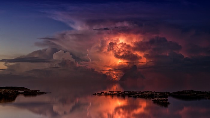 Thunderstorm over the ocean with lightning