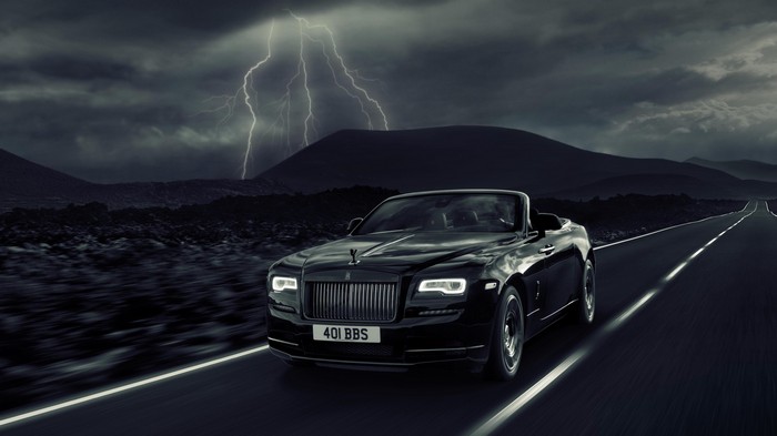 Rolls Royce Dawn driving on a stormy road