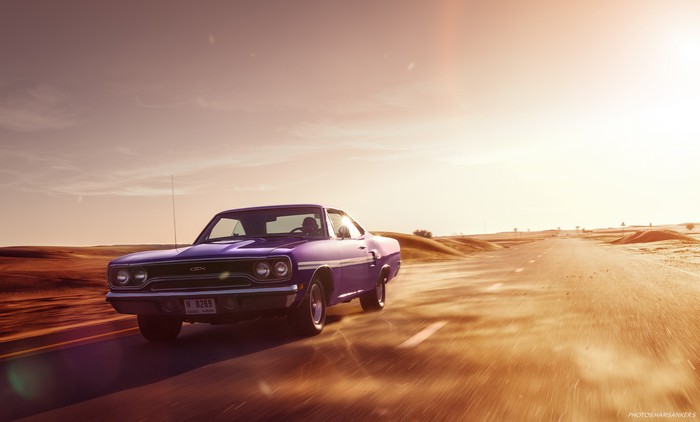 Purple Plymouth GTX driving on desert road