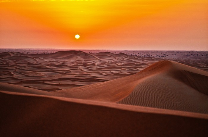 Desert sand dunes at sunrise or sunset
