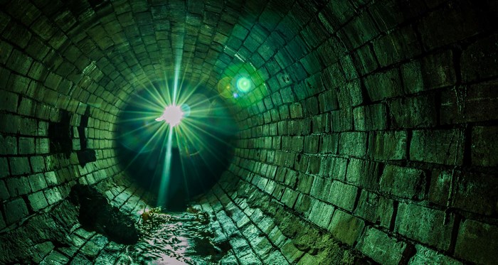 Green brick tunnel with light source