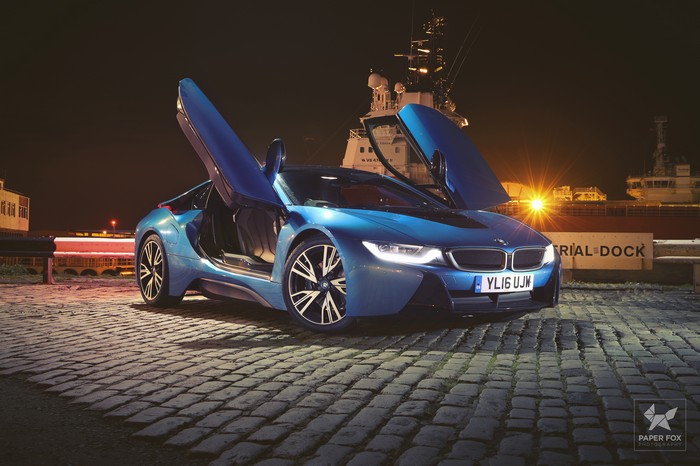 Blue BMW i8 with doors open at night