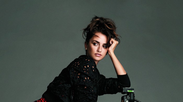 Penelope Cruz posing with a camera tripod