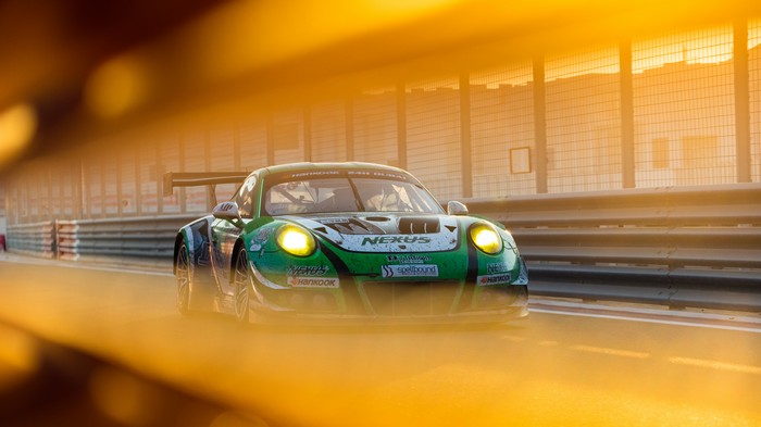 Green Porsche 911 GT3 R race car on track
