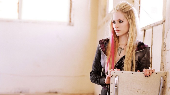Avril Lavigne sitting in a room